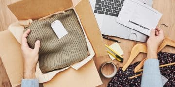 Business owner packing online order to delivery to customer. Preparing parcel box with clothes product from online shop