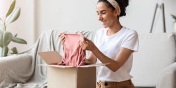 Happy young woman opening carton box, checking delivery, copy space